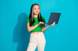© deagreez - Photo of nice young girl hold laptop wear green t-shirt isolated on teal color background