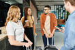 © LIGHTFIELD STUDIOS - A group of diverse businesspeople in casual attire stand together in a hotel lobby with their luggage, ready for a trip.