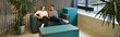 © LIGHTFIELD STUDIOS - Two coworkers relax and chat on a couch in a modern workspace, reflecting a startup teams dynamic lifestyle.
