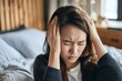 © alisaaa - Problems with headache One woman, Japanese woman having headache while lying on bed in her bedroom at home