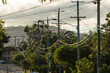© Austockphoto - Power lines suspended on electricity poles on a street in Brisbane, Queensland