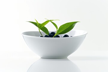 Wall Mural - Fresh green tea leaves with blueberries in a white bowl