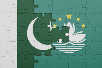 Wall Mural - puzzle with the colourful national flag of Macau and flag of pakistan .