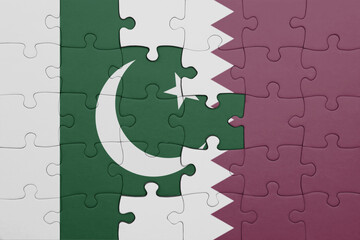 Wall Mural - puzzle with the colourful national flag of qatar and flag of pakistan .