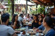 © alisaaa - People sitting outdoors in restaurant Multi-ethnic group of people, men and women sitting outdoors in pub