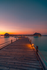 Sticker - Amazing beach landscape. Beautiful Maldives sunset seascape view. Horizon colorful sea sky clouds, over water villa pier pathway. Tranquil island lagoon, tourism travel background. Exotic vacation