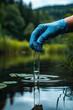 © ebhanu - A hand in a glove collects a water sample in a test tube, representing the concept of water purity analysis, environment, and ecology.