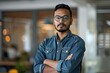 © Robert - Portrait of a young successful Indian programmer, employer standing in an office center.