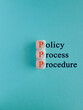 © Liudmila - Policy, process, procedure symbol. Orange words 'Policy, process, procedure' written on wooden cubes on beautiful blue background. Business and policy, process, procedure concept
