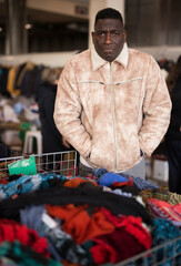 Wall Mural - Guy from South Africa sells used clothes at a flea market.