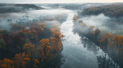 Wall Mural - View of a serene river meandering through a misty landscape with fall colors touching the trees.