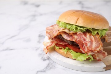 Wall Mural - Delicious burger with bacon, patty and tomato on white marble table, space for text