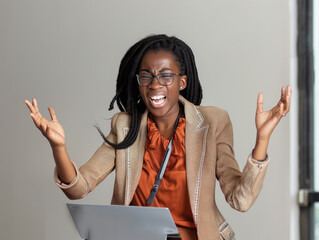 Wall Mural - Young African American Businesswoman throwing laptop in frustration