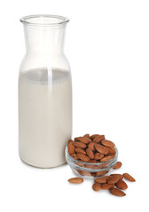 Wall Mural - Glass jug of almond milk and almonds isolated on white