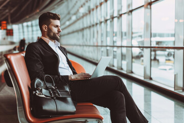 Businessman in Black Suit Working at Airport