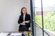 © Charlie's - Portrait of confident asian professional business woman executive manager successful standing in office