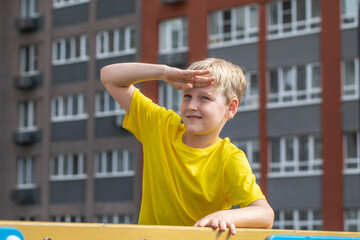 Wall Mural - Portrait of a little boy wearing a yellow t-shirt