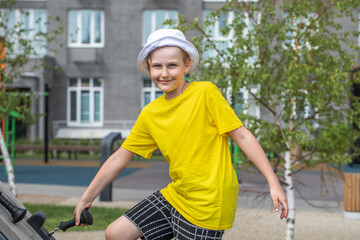 Wall Mural - Portrait of a little boy wearing a yellow t-shirt