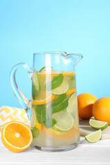 Sticker - Freshly made lemonade with mint in jug on white wooden table against light blue background