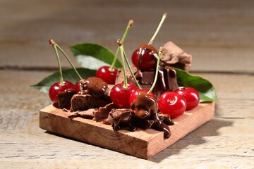 Wall Mural - Fresh cherries with milk chocolate on wooden table