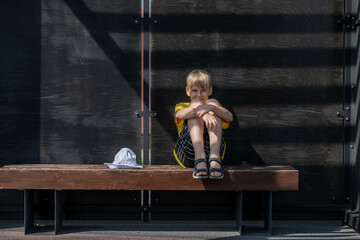 Wall Mural - Portrait of a little boy wearing a yellow t-shirt