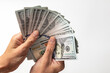 © Serhii - Contributions to business. American money is in the hands of a man. Dollars in hand. The concept of solvency