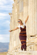 © brahim - Middle-aged Spanish female tourist comes to Denizli Pamukkale Laodicea for a trip and poses with fun next to the historical columns
