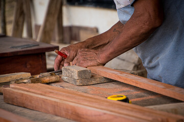 Elderly carpenter working in his home workshop