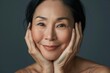 © Piyaphorn - Embrace the glow of healthy skin with studio isolate shots featuring mature Asian women's facial care practices.