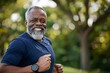 © Olsek - Smiling elderly man jogging in park. Healthy lifestyle and fitness concept. Bright and energetic. Perfect for promoting wellness brands and inspirational content. Generative AI