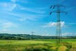 © Olena - Transmission Poles. High Voltage Electrical Tower in Colorful Summer Landscape