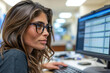© Vera - female nurse sitting at a computer, managing and auditing medical coding and billing codes on a spreadsheet.