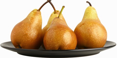 Wall Mural - on a white background, a close-up of three yellow pears on a black ceramic plate.