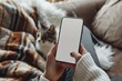 © VolumeThings - Mockup image of cellphone in female hands cat in background cozy home setting hands using smartphone in background