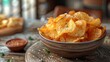 © iVGraphic - Bowl of salted potato chips on rustic table, appetizing snack concept