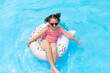 © Irina Mikhailichenko - Little girl having fun on vacation at the hotel pool. Colorful vacation concept. Summer outdoor activity during family vacation in tropical resort. Beach and water toys. Sun protection.
