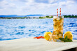 © magdal3na - Glass of cold cocktail with lemon and mint on the wooden table with beach and sea and sky background.