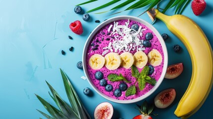 Wall Mural -  Blue backdrop featuring a smoothie bowl brimming with sliced bananas, kiwis, strawberries, and shredded coconut