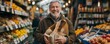 © gearstd - Cheerful senior man with a gray beard and jacket holds a paper bag full of groceries, standing amidst a fruit marketplace