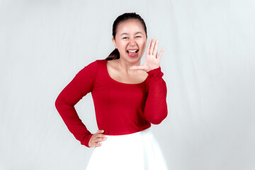 Wall Mural - Excited Asian woman wearing a red shirt giving number 12345 by hand gesture