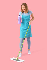 Wall Mural - Young woman with bottle of detergent and mop on pink background