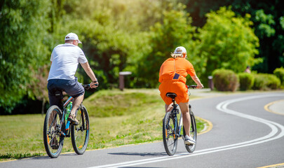 Wall Mural - Cyclists ride on the bike path in the city Park
