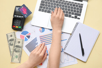 Canvas Print - Female hands with laptop, credit card, money and charts on beige background. House rent concept