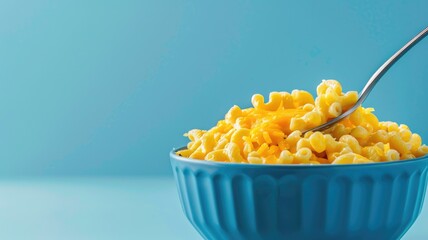 Wall Mural - Creamy macaroni and cheese in blue bowl, fork