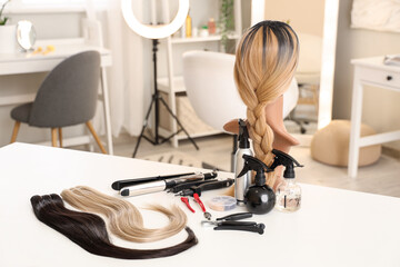 Poster - Mannequin with wig and hair extension tools on table in beauty salon