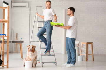 Poster - Happy young couple with ladder and cute dog planning painting their new house