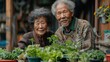 © svastix - An elderly couple, both wearing cozy sweaters, pose together in a garden setting with various potted plants, displaying their bond and love for gardening.