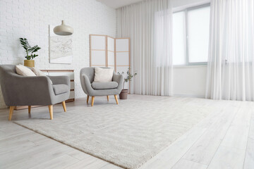 Wall Mural - Interior of stylish living room with folding screen, chest of drawers, armchairs and carpet