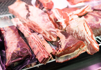 Poster - Pieces of beef meat laid out for sale in refrigerated display