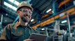 © Kien - A man in an industrial setting, wearing safety glasses and hard hat while holding up his tablet with the screen facing towards camera